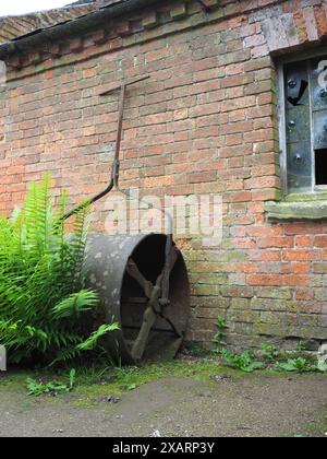 Antico rullo per prati nel giardino vittoriano del cottage Foto Stock