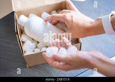 Imballaggio ecologico di pacchi e riempitivo biodegradabile bianco. La scatola è riempita con un riempitivo di sicurezza per l'ambiente. Consegna di merci, pacchi, consegna Foto Stock
