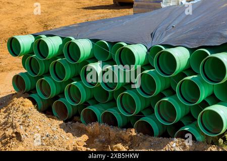 Nei cantieri sono installati tubi in PVC verde per l'installazione di sistemi di alimentazione idrica per la nuova residenza Foto Stock