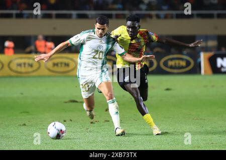 Kampala, Uganda. 10 giugno 2024. Rogers Mato (R) dell'Uganda si confronta con Youcef Attal dell'Algeria durante la partita del gruppo G delle qualificazioni alla Coppa del mondo FIFA 2026 tra Uganda e Algeria a Kampala, la capitale dell'Uganda, il 10 giugno 2024. Crediti: Hajarah Nalwadda/Xinhua/Alamy Live News Foto Stock