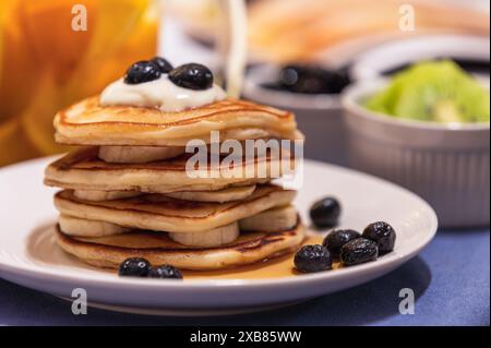 Pancake ricoperti di frutti di bosco freschi sul piatto Foto Stock