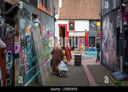 La gente cammina nel vicolo costellato di graffiti King Place fuori Bond Street e di fronte al Theatre Royal Stage Door in Bond St, Brighton, East Sussex, Regno Unito. Foto Stock