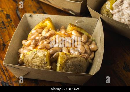 Patate al forno caricate in casa con Cheddar, fagioli renali e salsa agrodolce Foto Stock