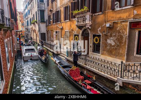 Città di Venezia in Italia, canale Rio della veste con gondole e gondoliere in attesa dei clienti, quartiere San Marco. Foto Stock