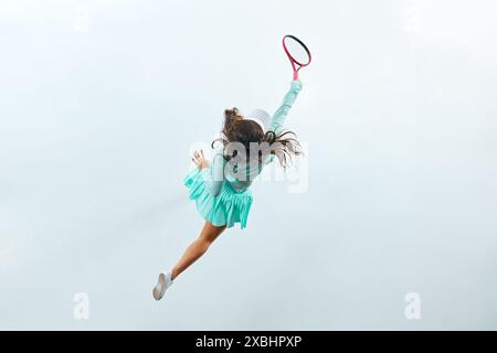 Foto dinamica della vista dall'alto del giocatore di badminton in azione su sfondo bianco dello studio. Vista aerea. Foto Stock
