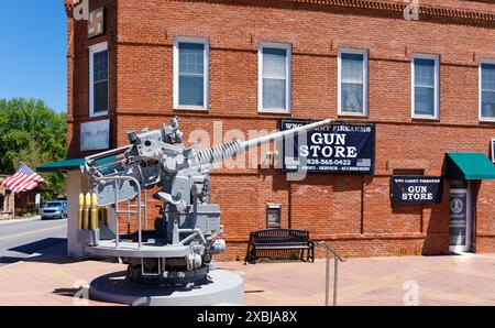 Clyde, North Carolina, USA-4 maggio 2023: Negozio di armi del centro città e mitragliatrice militare da 50 mm. Foto Stock