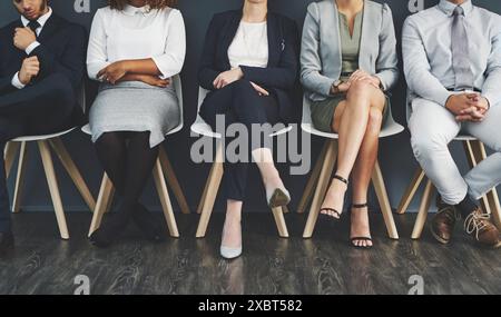 Business, dipendenti e parete d'ufficio con gambe, colloqui di lavoro e selezione del personale per la carriera delle persone in azienda. Sala d'attesa, coda e candidato Foto Stock