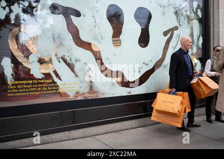 Gli acquirenti carichi di borse Louis Vuitton si trovano fuori dal grande magazzino Selfridges in Oxford Street, il 13 giugno 2024, a Londra, Inghilterra. Foto Stock