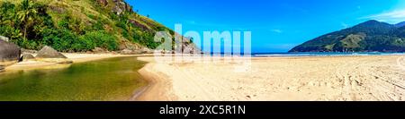 Immagine panoramica della spiaggia tropicale di Bonete a Ilhabela con il fiume che scorre nel mare Foto Stock