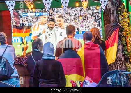 Public Viewing an der Leopoldstraße, Eröffnungsspiel Deutschland gegen Schottland, UEFA EURO 2024, München, 14. Juni 2024 Deutschland, München, 14. Juni 2024, deutsche Fußballfans beim Public Viewing an der Eröffnungsspiel beim Leopoldstraße Deutschland gegen Schottland, Endstand 5:1, hier in der ersten Halbzeit: deutsche Nationalspieler jubeln über das 2:0, Fußballfreunde mit Deutschlandfahnen bei der Live-Übertragung im Außenbereich einer Gastwirtschaft, die Fußball-Europameisterschaft dauert bis zum 14. Juli, Fußball, Sport, *** visione pubblica a Leopoldstraße, partita di apertura Germania vs. SCO Foto Stock