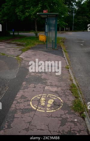 Un vecchio cartello Covid, state liberi e lasciate il pavimento dello spazio sbiadito vicino ad una fermata dell'autobus a West Wellow sulla A36 nell'Hampshire, Inghilterra. Residuo del blocco. Foto Stock