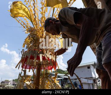 Un uomo prepara oggetti di scena tradizionali per il rituale Melanau serahang durante il Kaul Festival Foto Stock