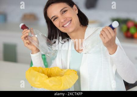 ragazza giovane che ordina bottiglie di plastica Foto Stock