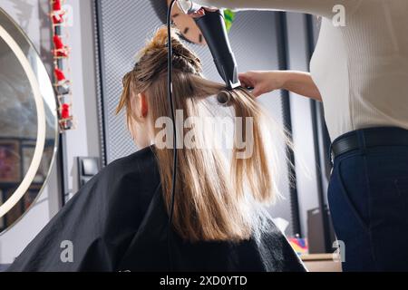 asciugacapelli per parrucchiere e pettine nel salone di bellezza, primo piano per asciugare i capelli, concetto di cura personale Foto Stock