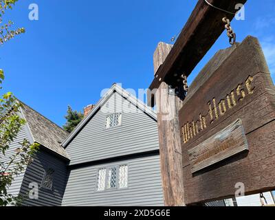 Un cartello di fronte alla Witch House di Salem, Massachusetts, è decorato con zucche e gambi di mais per Halloween in un giorno d'autunno. Foto Stock