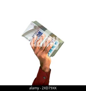 Mano rialzata che tiene in mano pile di banconote del franco cfa dell'Africa occidentale isolate su sfondo bianco Foto Stock