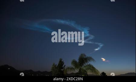 Vapor Trail o contrapporsi al lancio di un razzo poco dopo il tramonto Foto Stock