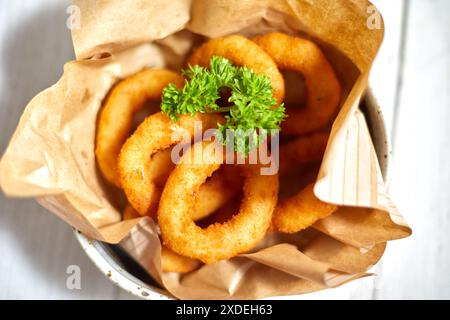Anelli di cipolla fritti su fondo bianco Foto Stock