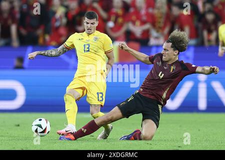 Colonia, Germania. 22 giugno 2024. Valentin Mihaila rumeno e Wout Faes belga lottano per la palla durante una partita di calcio tra la nazionale belga Red Devils e la Romania, sabato 22 giugno 2024 a Colonia, Germania, seconda partita nella fase a gironi dei campionati europei UEFA Euro 2024. BELGA PHOTO BRUNO FAHY credito: Belga News Agency/Alamy Live News Foto Stock