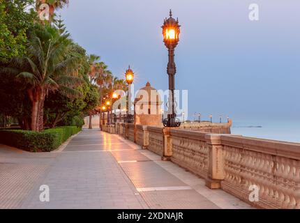 Vecchio Embankment con belle lanterne all'alba a Cadice, Andalusia, Spagna Foto Stock