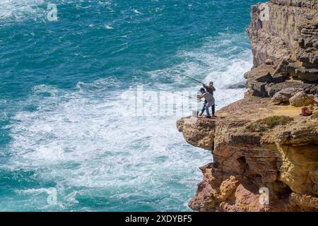 Pesca di Angler dalla scogliera, Parco naturale della Costa Vicentina, Alentejo, Portogallo. Foto Stock