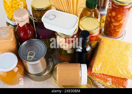 Cibo di sopravvivenza di emergenza impostato sul tavolo da cucina bianco con vista ad angolo alto Foto Stock