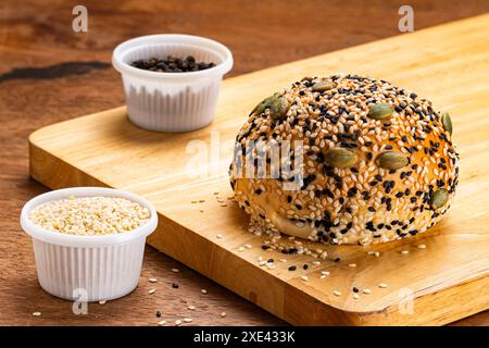 Vista dall'alto del panino di hamburger fatto in casa cosparso di sesamo bianco e nero e semi di zucca. Foto Stock