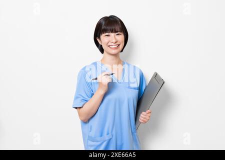 Lavoratrice sanitaria femminile con cartelle cliniche Foto Stock