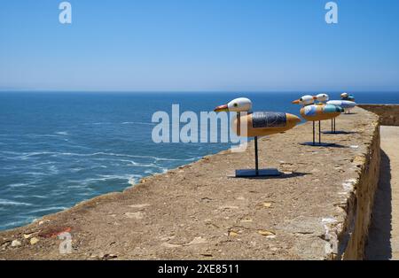 Installazione artistica di gabbiani seduti sul parapetto del faro di Nazare. Nazista. Portogallo Foto Stock