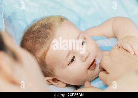 Madre che si lega teneramente al suo bambino, fissandosi l'un l'altro con amore e felicità in un ambiente sereno Foto Stock