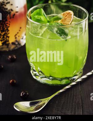 Cocktail alcolico al basilico con basilico verde Foto Stock