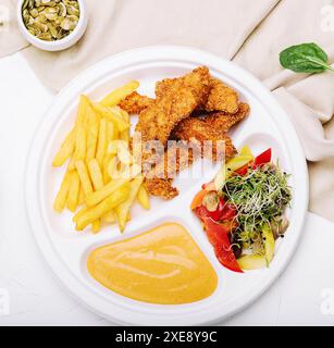 Pepite di pollo con patatine fritte e salsa di senape Foto Stock