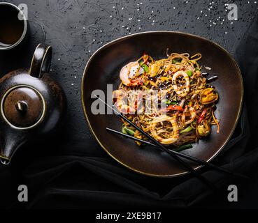 Wok piccante asiatico con tagliatelle, gamberi e verdure Foto Stock