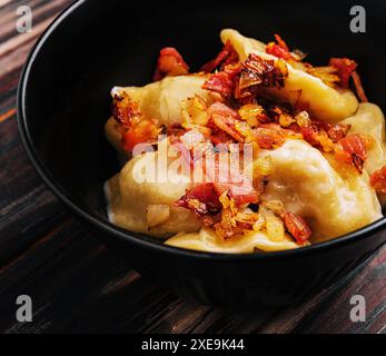 Gnocchi di patate al forno con pancetta fritta e cipolle Foto Stock