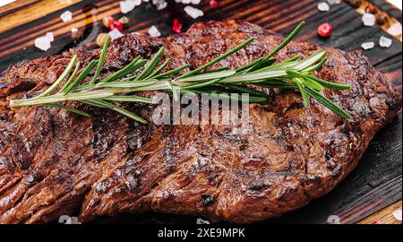 Bistecca di manzo grigliata su tavola di legno Foto Stock