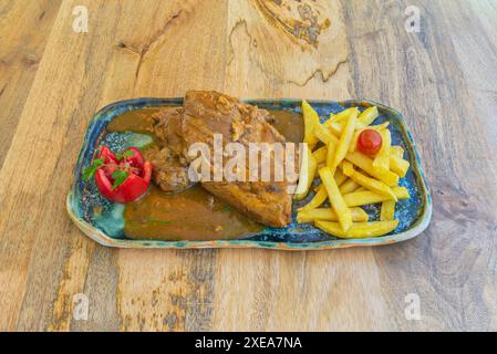 Ricetta per le costolette di maiale arrosto con cipolle e patate, è un classico in molte case Foto Stock