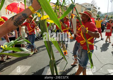ACI TREZZA, ITALIA - 24 GIUGNO 2024 - Festa tradizionale di San Giovanni. Sfilata tradizionale di San Giovanni con pisci a mari dove riproducono la caccia al tonno. Il tonno viene derubato da un giovane che finalmente riesce a fuggire dai pescatori Foto Stock