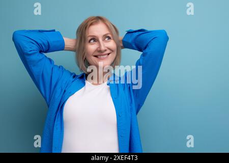 Donna matura bionda da da sogno con taglio di capelli su sfondo studio Foto Stock