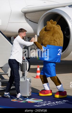 Dortmund, Germania. 28 giugno 2024. Calcio: Campionato europeo, nazionale tedesca in vista del turno dei 16 contro la Danimarca. Niclas Füllkrug dà il benvenuto alla mascotte Albärt all'aeroporto di Dortmund. Crediti: Bernd Thissen/dpa/Alamy Live News Foto Stock