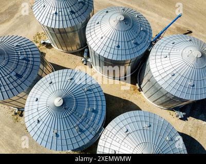 Vista aerea di grandi contenitori di grano metallico sui terreni agricoli a nord di Calgary, Alberta; Alberta, Canada Foto Stock