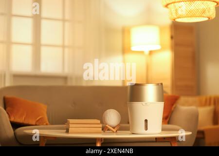 Umidificatore moderno sul tavolino da caffè in soggiorno la sera Foto Stock