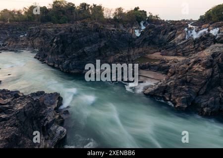 Lunga esposizione delle cascate li Phi Somphamit con cascate su una scogliera rocciosa con sponde sabbiose e correnti fluviali in Laos; Khon Tai, Laos Foto Stock