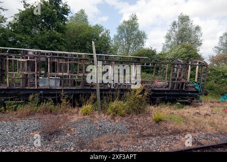Carcassa di una vecchia carrozza ferroviaria subito dopo la stazione di Wittersham Road sulla Kent and East Sussex Railway. Foto Stock