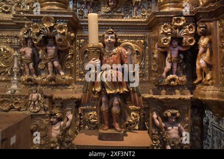 Portogallo, Lagos, 11.06.2024 Kirche Santo Antonio die 1707 errichtete Kirche wurde 1769 wieder aufgebaut. Die vergoldeten Holzschnitzereien im Barockstil, Die den Innenraum schmücken, werden zu den schönsten des Landes gerechnet. Foto: ein Engel, als Kerzenleuchter, in der Kirche Santo Antonio Stadt Lagos *** Portogallo, Lagos, 11 06 2024 Chiesa di Santo Antonio la chiesa, costruita nel 1707, fu ricostruita nel 1769 le sculture in legno dorato in stile barocco che decorano l'interno sono considerate tra le più belle del paese foto di un angelo, come candelabro, nella chiesa di San Foto Stock