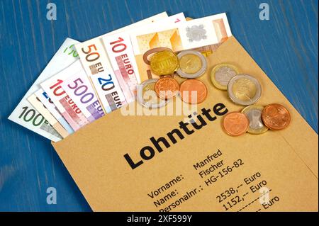 Lohntüte mit Euro Eine Lohntüte mit vielen Euro Banknoten und mit der Berechnung von brutto und netto *** pacchetto di pagamento con euro Un pacchetto di pagamento con molti Foto Stock