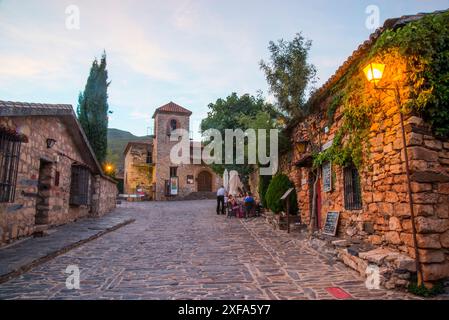 Strada e chiesa, Vista notte. Patones de Arriba, provincia di Madrid, Spagna. Foto Stock