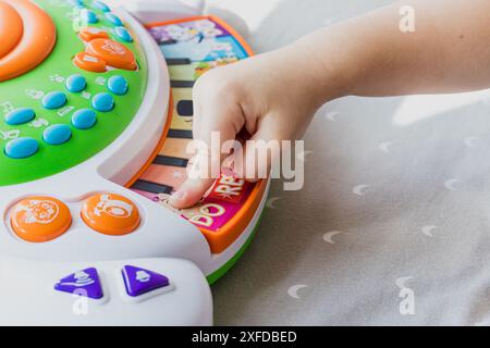 La mano piccola di un bambino che suona il piano Foto Stock