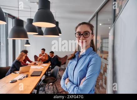 Donna d'affari che conduce un incontro con i colleghi di Modern Office. Foto Stock
