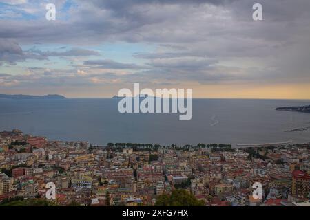Tramonto giallo sulla baia e sul mare in Italia, vista dall'alto. Baia di Napoli in serata al tramonto, vista panoramica, passeggiate turistiche italiane Foto Stock