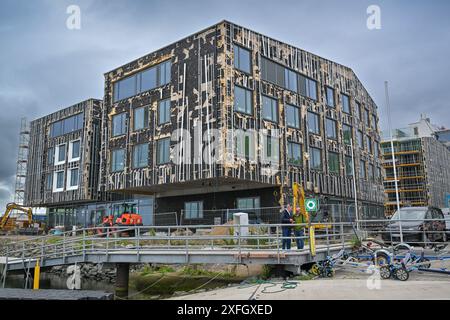 Warnemünde: Baumängel bei 27 Millionen Sportschulen Neubau Warnemünde, Deutschland. Blick auf den Neubau der Sportschule Warnemünde mit Boots- und Sporthalle. So sieht ein 27 Millionen Neubau gefördert mit Mitteln der Europäischen Union und dem Europäischen Fonds für regionale Entwicklung. Die Kosten sind seit der Grundsteinlegung 2022 um etwa sieben Millionen Euro gestiegen. Die Fassade ist schon vor der Fertigstellung stark beschädigt. *** Warnemünde difetti di costruzione in 27 milioni di nuovo edificio scolastico sportivo Warnemünde, Germania Vista del nuovo edificio scolastico sportivo Warnemünde con barca a Foto Stock